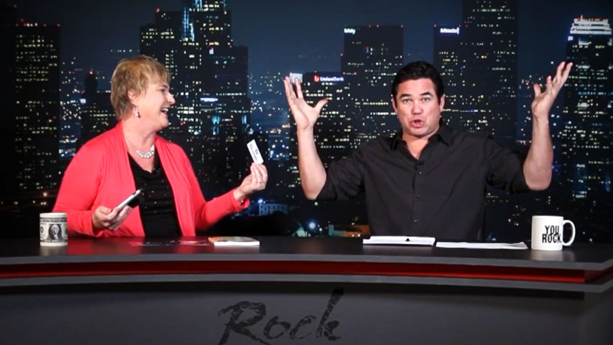 Image of Michelle Calloway on a TV set with Dean Cain as he demonstrates that his mind is blown away
