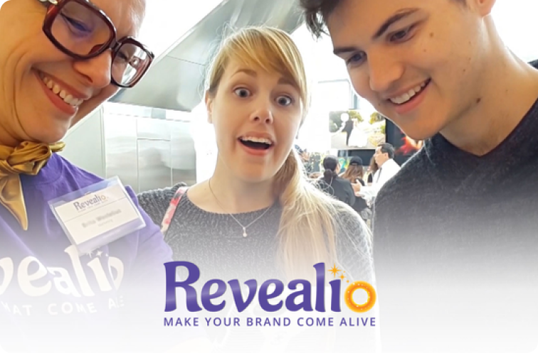 Image of Revealio staff showing AR technology to a bewildered couple
